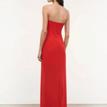 A person viewed from behind wearing the floor-length red Liliana Dress, a strapless gown perfect for special occasions.