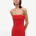 A person wearing a solid red strapless midi Liliana Dress for special occasions.