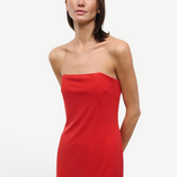 A person wearing a solid red strapless midi Liliana Dress for special occasions.