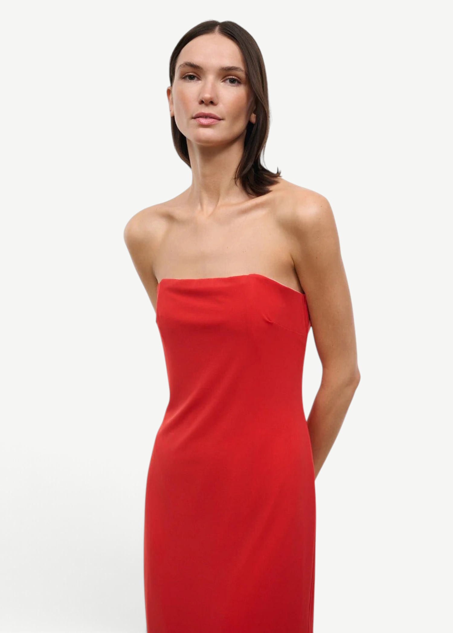 A person wearing a solid red strapless midi Liliana Dress for special occasions.