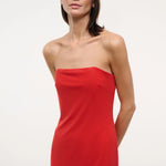 A person wearing a solid red strapless midi Liliana Dress for special occasions.