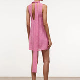 Back view of the pink Mini Albee Dress, a sleeveless mini dress with a low back, tie-neck detail, and floral embroidery.