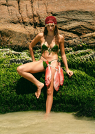 KABE SHOP INC Zahi Hat, a vibrant red artisanal skullcap with intricate shell embellishments worn by a model.