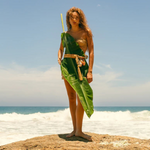 KABE SHOP INC Jibe belt featuring natural shell adornments worn by a woman on a beach with a large tropical leaf