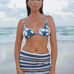 KABE SHOP INC Geo Flower triangle bikini top with blue and white floral print worn by a woman on a beach