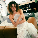 KABE SHOP INC upcycled vintage lace handkerchief dress with halter neck worn by a model in a modern living room