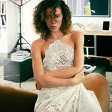 KABE SHOP INC upcycled vintage lace handkerchief dress with halter neck worn by a woman in a modern interior