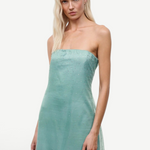 The Amara dress is a sage green, strapless midi dress featuring a sheer overlay adorned with scattered rhinestones for an elegant statement.