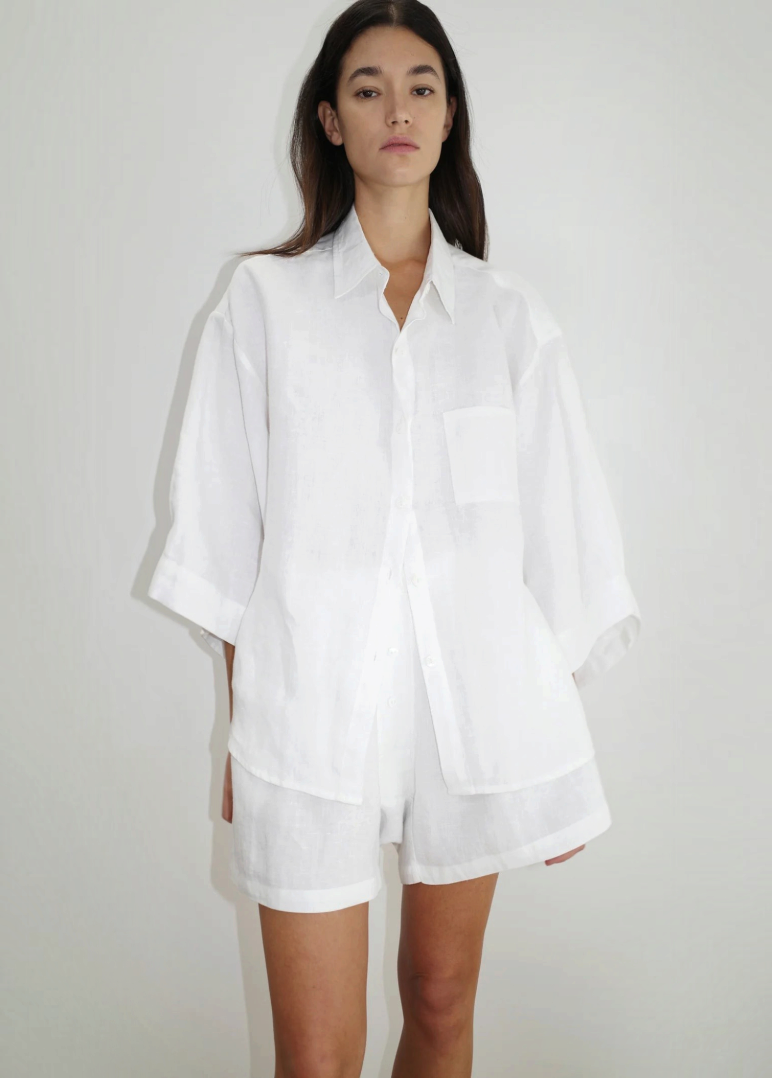 Model wearing KABE SHOP INC 03 Set, a white oversized French linen shirt and matching loose boxer-style shorts.