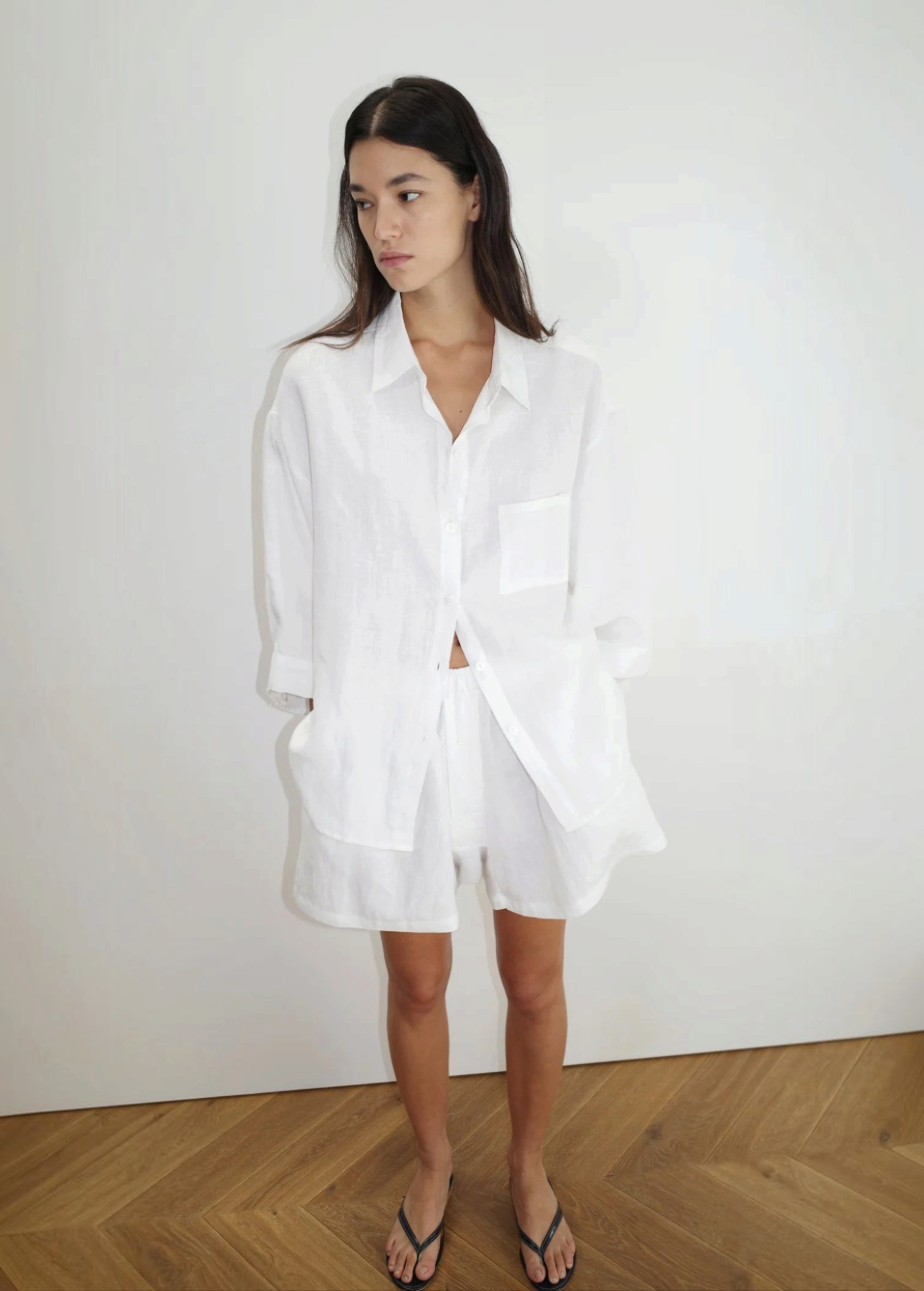 Model wearing KABE SHOP INC 03 Set, a white oversized French linen shirt and matching loose boxer-style shorts.