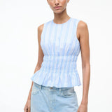 Culver Top in a light blue and white striped sleeveless peplum style with a smocked waist for a feminine silhouette.