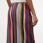 Wide-leg Mateo Pant with a colorful vertical stripe pattern and an elastic waistband, worn with a white ribbed top as a relaxed, warm-weather essential.