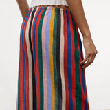 Wide-leg Mateo Pant with a colorful vertical stripe pattern and an elastic waistband, worn with a white ribbed top as a relaxed, warm-weather essential.