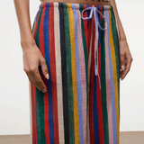 High-waisted, wide-leg Mateo pants featuring a colorful vertical stripe pattern, a drawstring waist, and a relaxed fit perfect for warm weather.