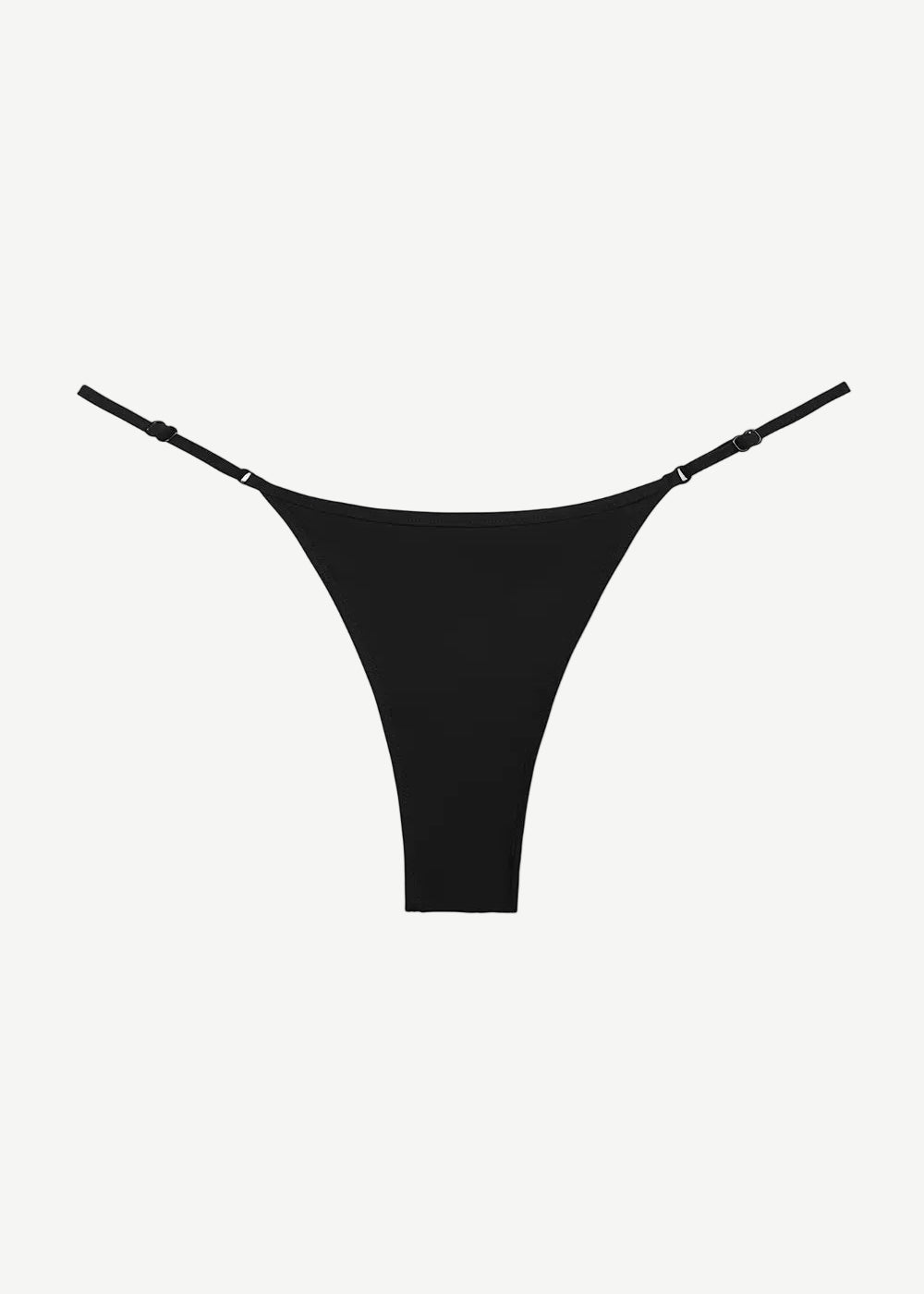 The Luna Bottom is a black low-rise bikini bottom featuring thin adjustable straps and crafted from ECONYL® regenerated nylon, showcased against a white background.