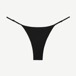 The Luna Bottom is a black low-rise bikini bottom featuring thin adjustable straps and crafted from ECONYL® regenerated nylon, showcased against a white background.