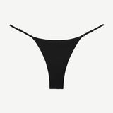The Luna Bottom is a black low-rise bikini bottom featuring thin adjustable straps and crafted from ECONYL® regenerated nylon, showcased against a white background.