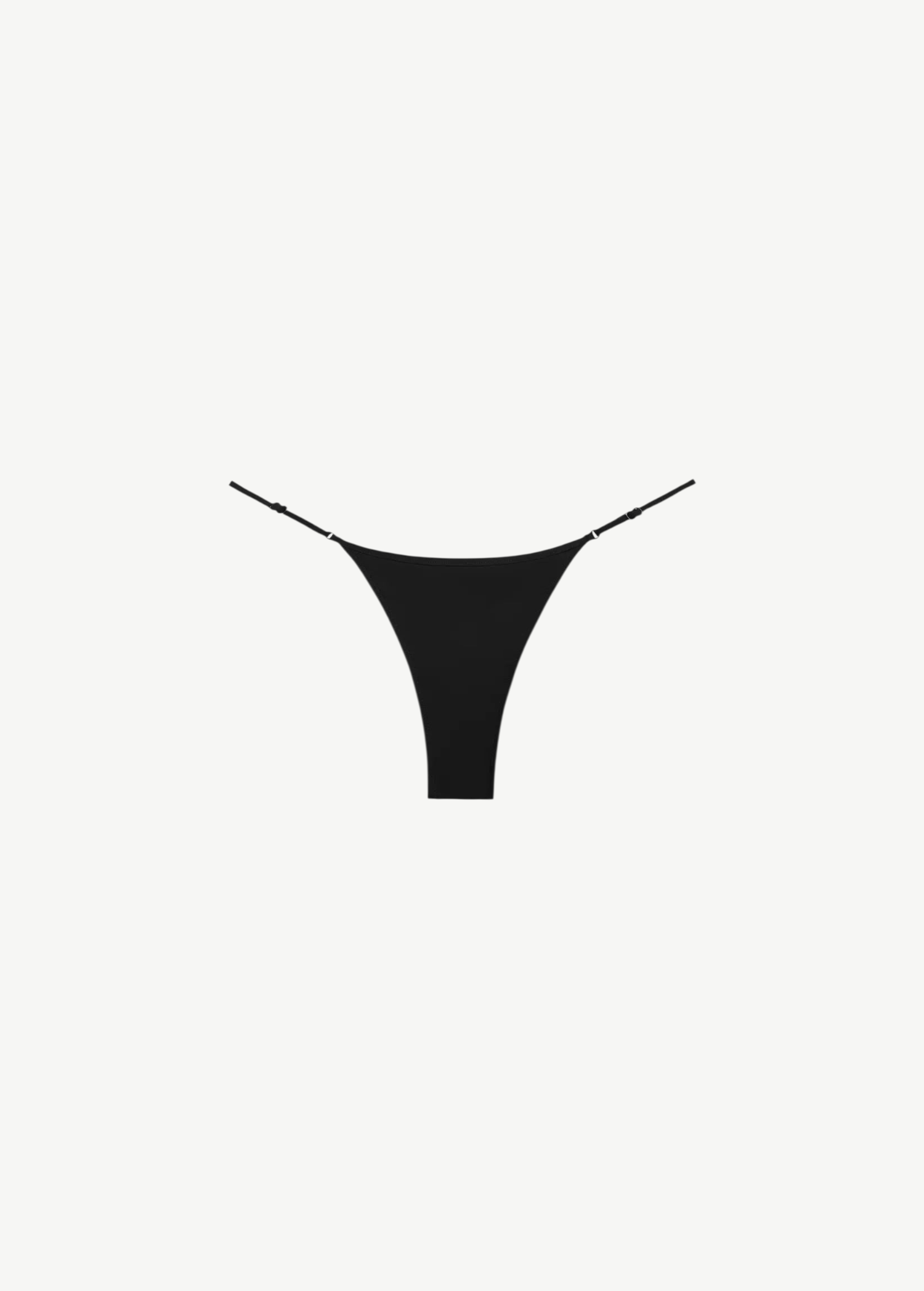 The Luna Bottom is a black low-rise bikini bottom featuring thin adjustable straps and crafted from ECONYL® regenerated nylon, showcased against a white background.