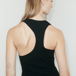 KABE SHOP INC black ribbed asymmetric racerback mini slip dress worn by a model, back view