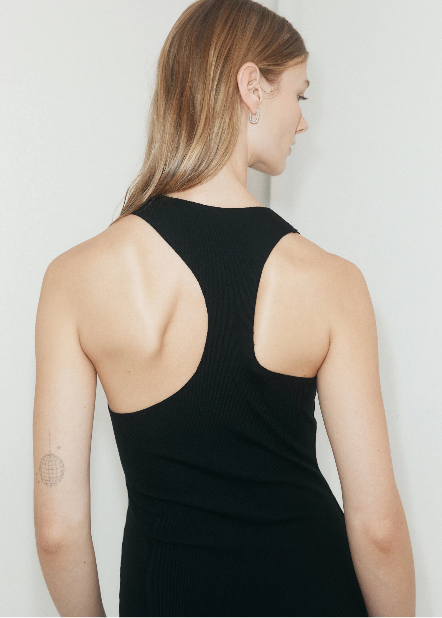 KABE SHOP INC black ribbed asymmetric racerback mini slip dress worn by a model, back view