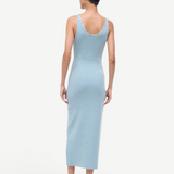 Back view of the Neva Dress, a sophisticated, light blue ribbed midi dress with circular button details along the back neckline for a timeless style.