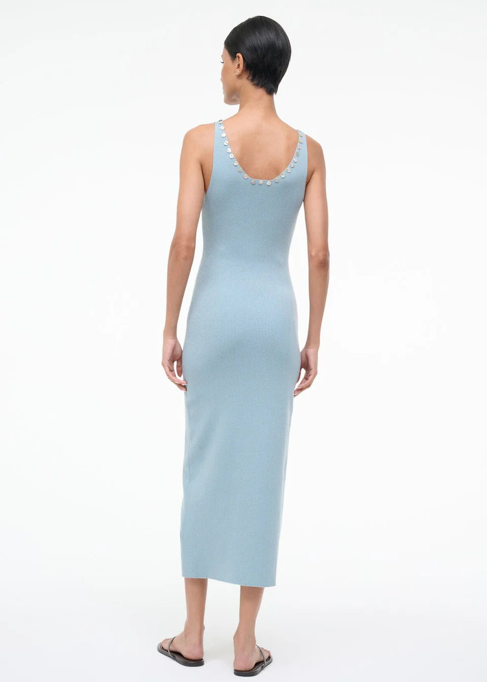 Back view of the Neva Dress, a sophisticated, light blue ribbed midi dress with circular button details along the back neckline for a timeless style.