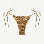 Praia Bottom triangle bikini bottom in leopard print, featuring adjustable side ties and minimal back coverage, displayed against a white background.