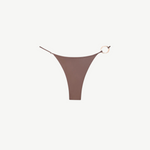 The Orb Luna Bottom is a brown high-cut bikini bottom crafted from ECONYL® regenerated nylon, featuring thin adjustable straps and a decorative gold ring detail on the right side, displayed on a white background.