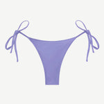 The Praia Bottom, an adjustable tie bikini bottom in a soft lavender shade and crafted from regenerated nylon for enhanced comfort, is showcased against a plain white background—a perfect option for anyone looking for eco-friendly swimwear with a customizable fit.