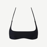 The Hamaca Top is a plain black bikini top with thin adjustable straps, crafted from sustainable compression fabric and displayed against a white background.