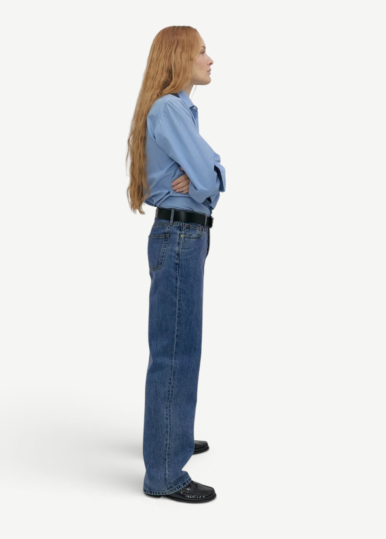 Model wearing KABE SHOP INC Everyday Jeans in a relaxed blue denim fit, styled with a light blue shirt and belt.