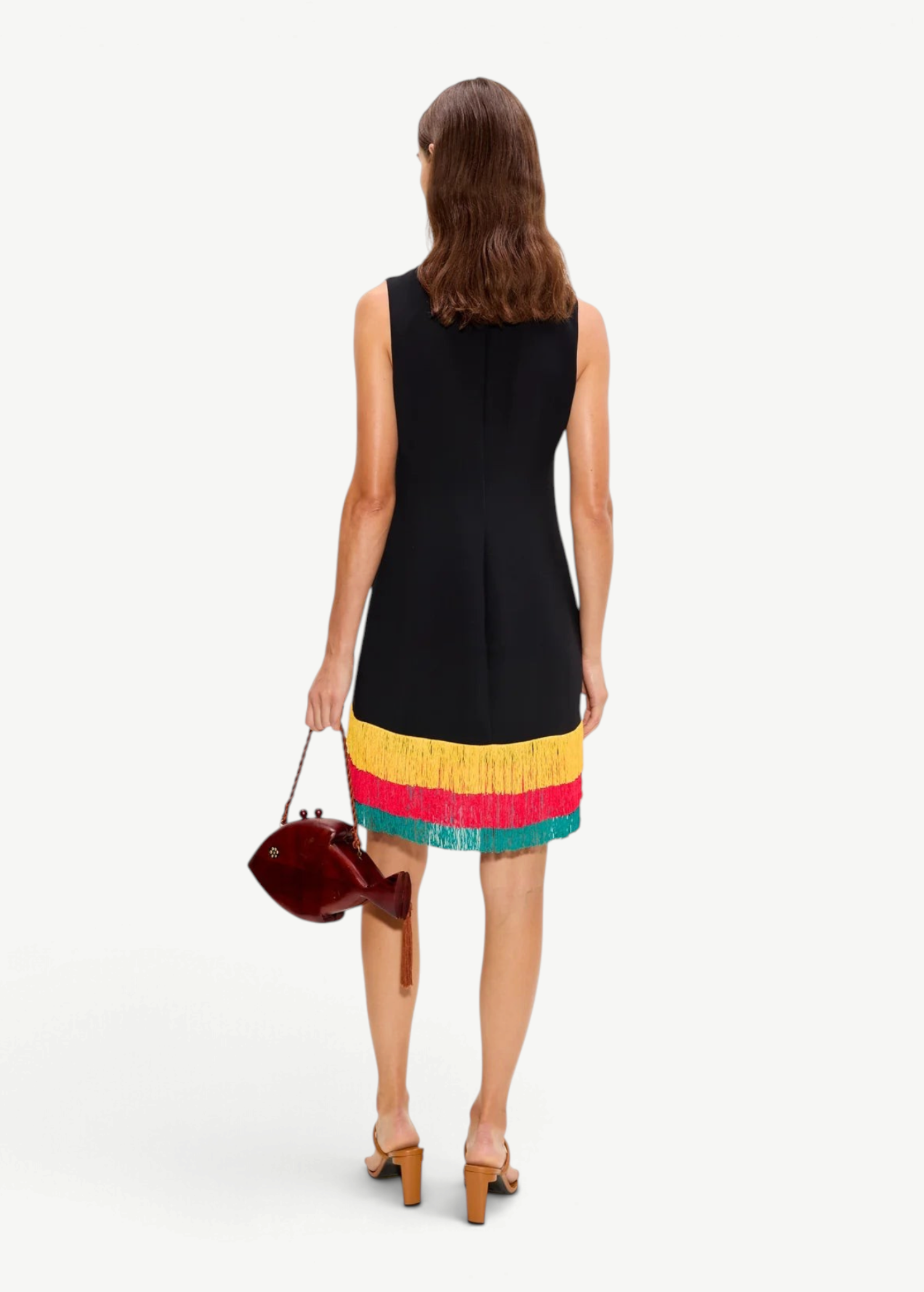 KABE SHOP INC Bowie mini dress in black with a multi-colored yellow and teal fringe hem, worn by a model from behind.