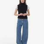 Model wearing KABE SHOP INC Sport Jean in relaxed blue denim with a black zip-up top against a plain background