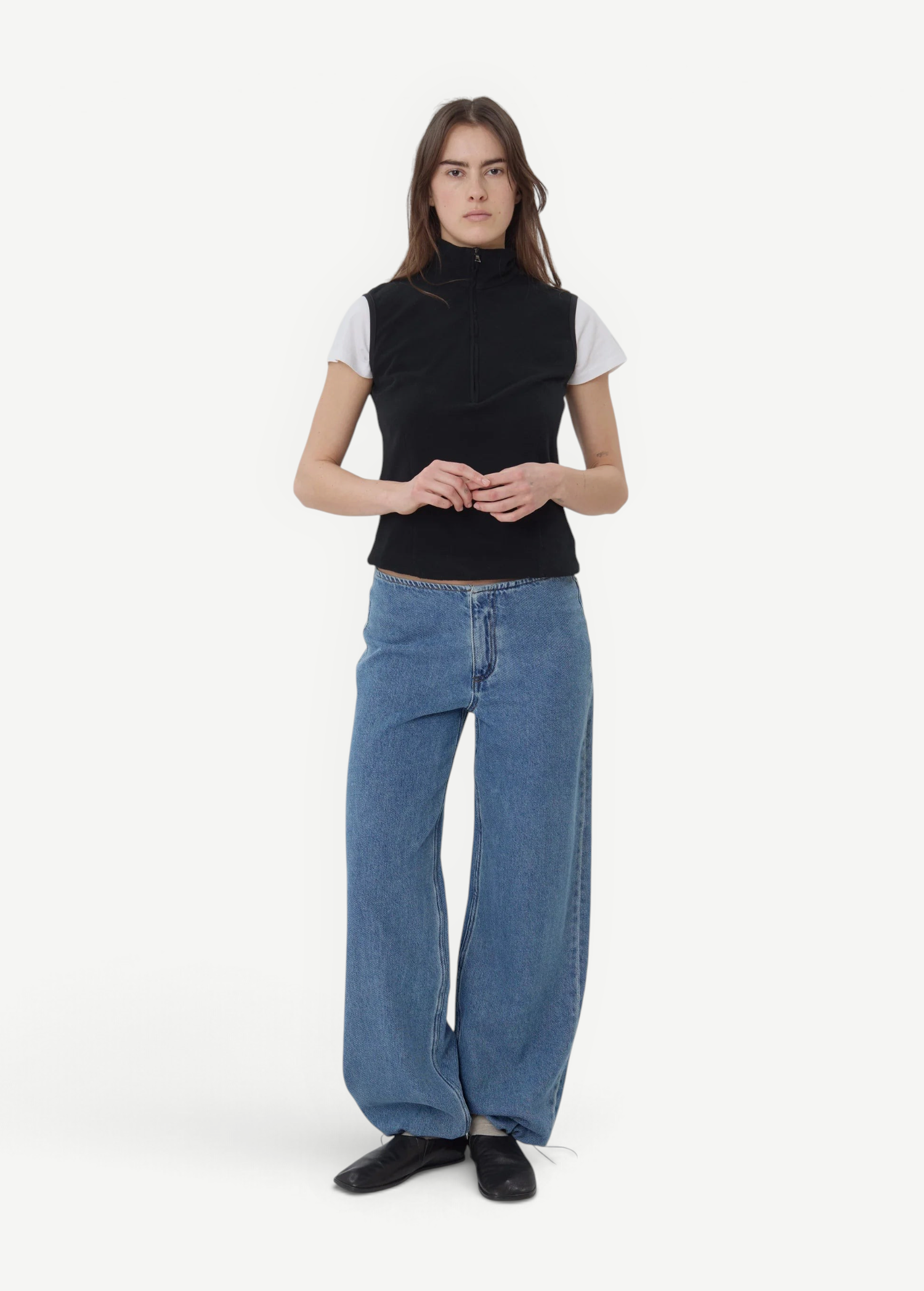 Model wearing KABE SHOP INC Sport Jean in relaxed blue denim with a black zip-up top against a plain background