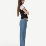 KABE SHOP INC Sport Jean in relaxed blue denim worn by a model in profile with a black vest and white t-shirt