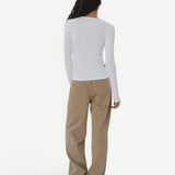 Model wearing KABE SHOP INC Sport Jean in tan denim with a relaxed fit, paired with a white long-sleeve top.
