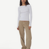 Model wearing KABE SHOP INC Sport Jean in tan denim with a relaxed fit and white long-sleeve top