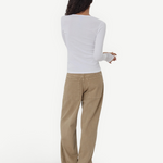 Model wearing KABE SHOP INC Sport Jean in tan denim with a relaxed fit and patch pockets, paired with a white top.