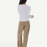 Model wearing KABE SHOP INC Sport Jean in tan denim with a relaxed fit and patch pockets, paired with a white top.