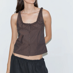 Model wearing a brown KABE SHOP INC Deiji Studios cotton poplin tank top with frill details and button-through front.