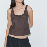 Model wearing a brown KABE SHOP INC Deiji Studios cotton poplin tank top with frill details and button-through front.