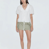 KABE SHOP INC Deiji Studios white cotton poplin top with collared V-neck, pintuck details, and drawcord hem on model