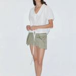 KABE SHOP INC Deiji Studios white cotton poplin top with collared V-neck, pintuck details, and adjustable hem