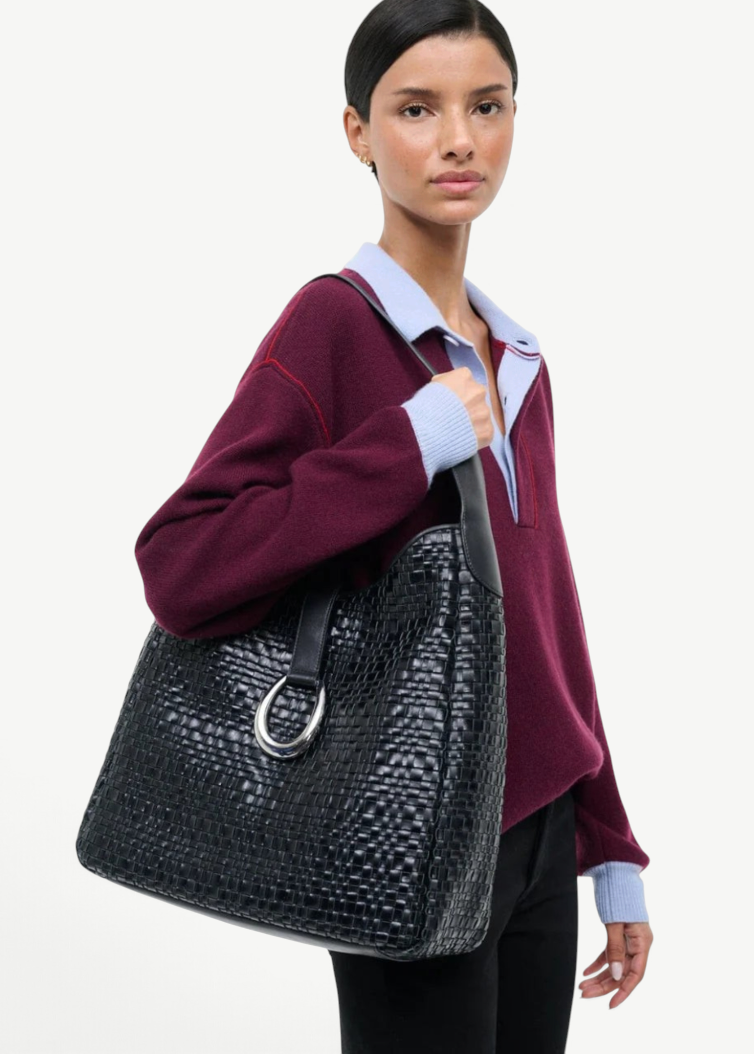 KABE SHOP INC Maya hobo bag in black woven leather with a silver metal ring detail, worn over the shoulder.