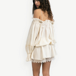 Model wearing KABE SHOP INC Isabella off-the-shoulder cream cotton jumpsuit with delicate lace trim and loose fit
