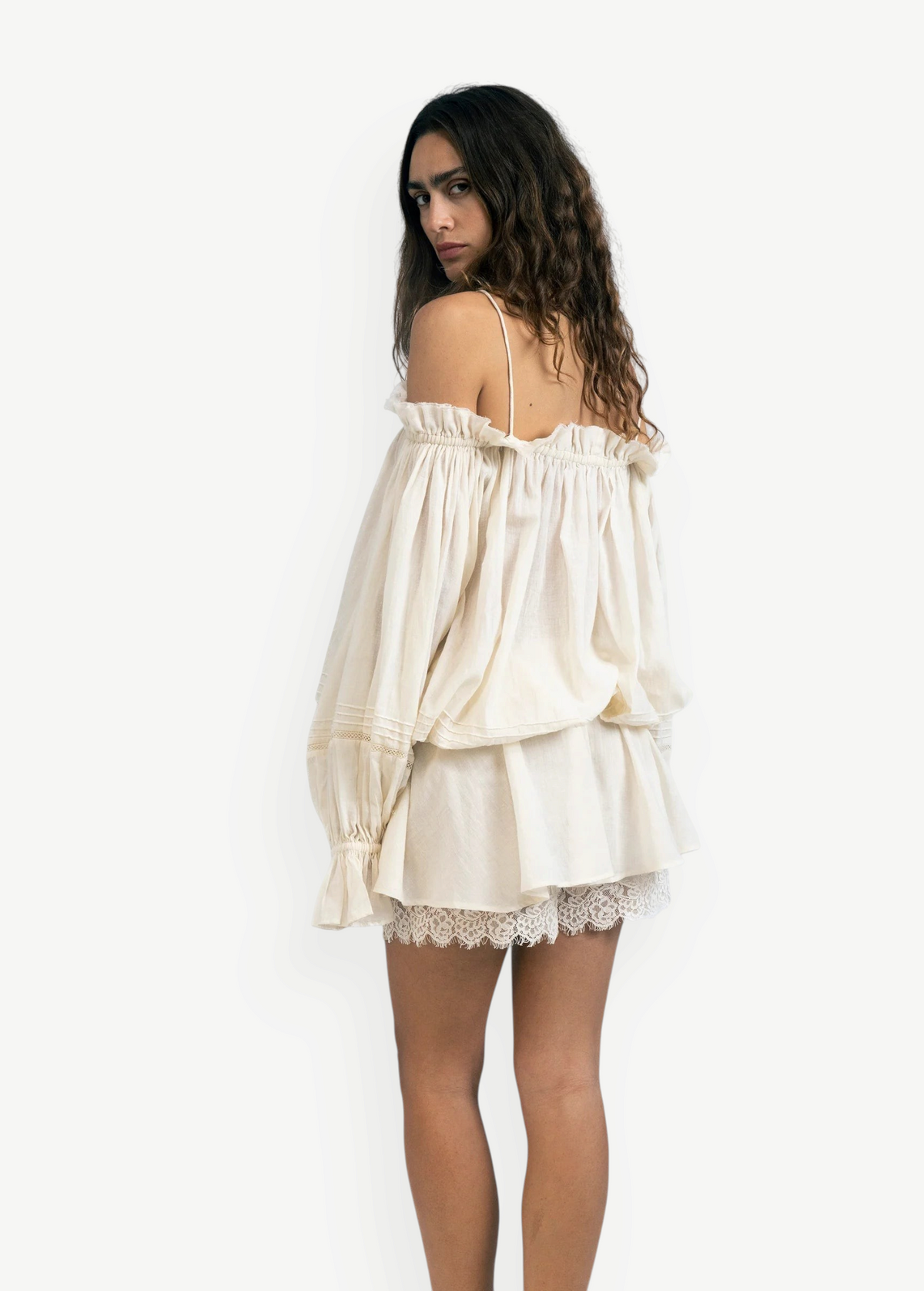 Model wearing KABE SHOP INC Isabella off-the-shoulder cream cotton jumpsuit with delicate lace trim and loose fit