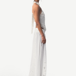 KABE SHOP INC Menorca trousers in white cotton with intricate lace patterns worn by a model in a side profile view