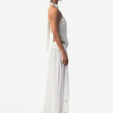 KABE SHOP INC Menorca trousers in white cotton with intricate lace patterns worn by a model in a side profile view