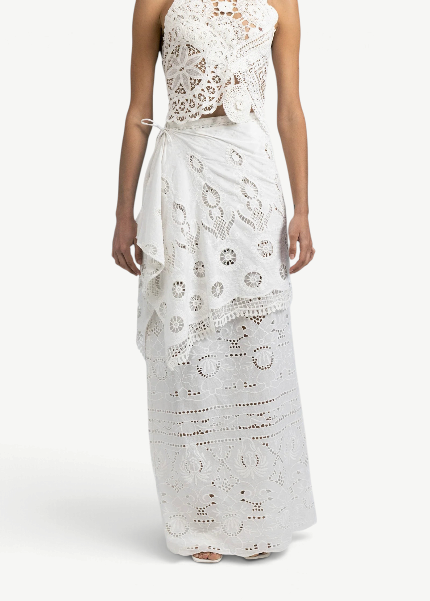 Model wearing a KABE SHOP INC Katinka white cotton skirt with intricate crochet and lace patchwork details.