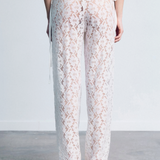KABE SHOP INC white lace trousers with a delicate floral pattern, handkerchief waistband, and fitted silhouette.